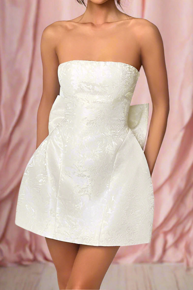 Amora White Strapless Structured Corseted Hourglass Mini Wedding Dress with Satin Jacquard Fabric, Basque Waist, and Large Detachable Bow- close up shot by Orange Blossom Bridal
