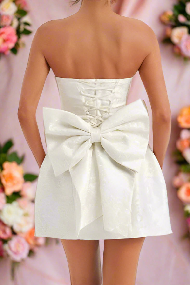 Amora White Strapless Structured Corseted Lace-up Hourglass Mini Wedding Dress with Satin Jacquard Fabric and Large Bow- back view by Orange Blossom Bridal