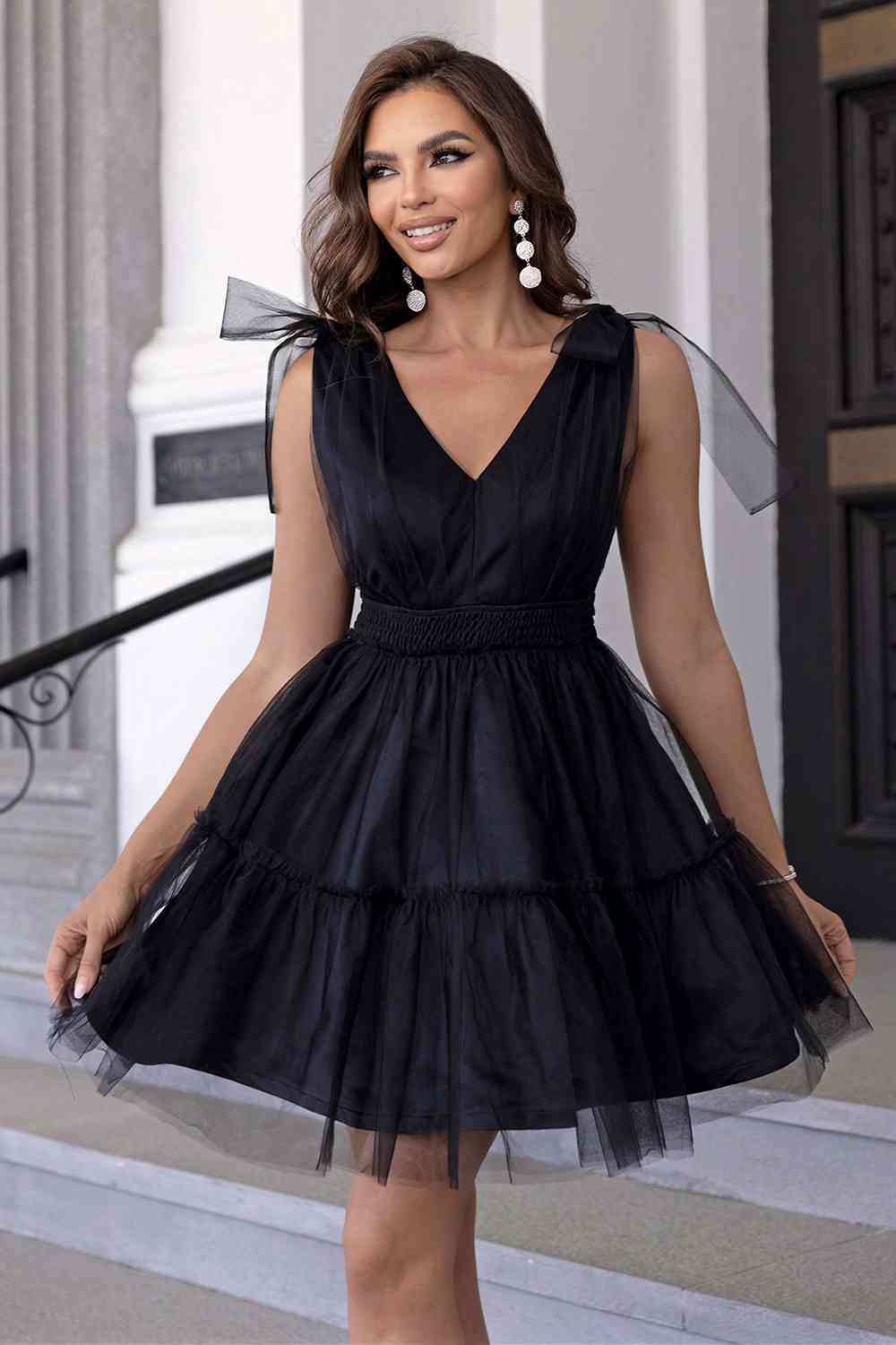 Arielle Black Tulle Mini Babydoll Bridesmaid, Party, Cocktail, or Homecoming Dress with Full Ballerina Skirt, V-Neckline, and Bow Details on the Shoulder Straps - Orange Blossom Bridal
