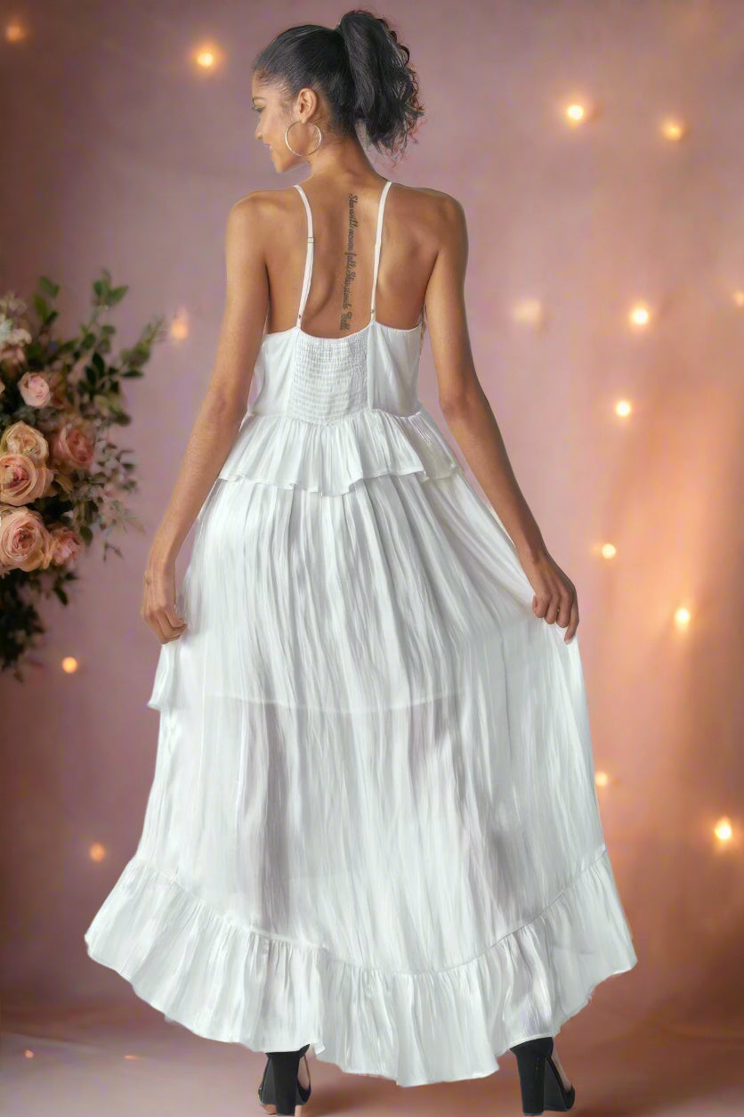 Ásta Modern Shimmering White Unstructured A-Line High-Low Maxi Wedding Dress With Adjustable Cami Straps, Ruffles, Smocking, and Peplum Detail by Orange Blossom Bridal.