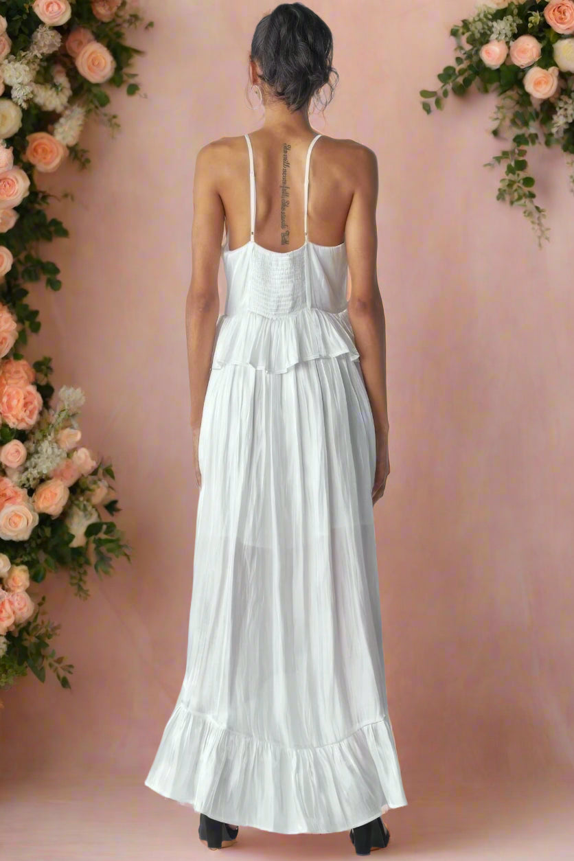Ásta Modern Shimmering White Unstructured A-Line High-Low Maxi Wedding Dress With Adjustable Cami Straps, Ruffles, Smocking, and Peplum Detail by Orange Blossom Bridal.